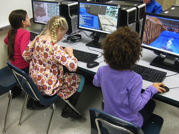 young girls at school computers playing minecraft